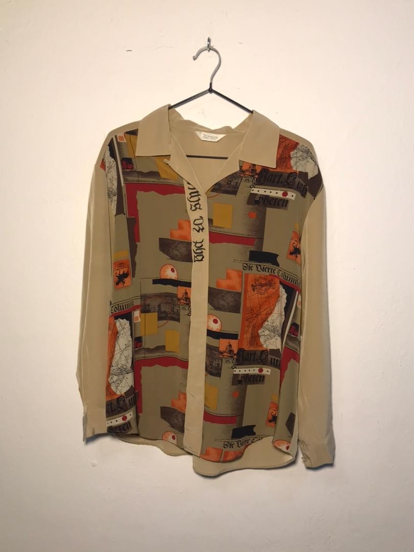 SPIRAL STORE beige long-sleeve button-up shirt with abstract graphic print and text details.