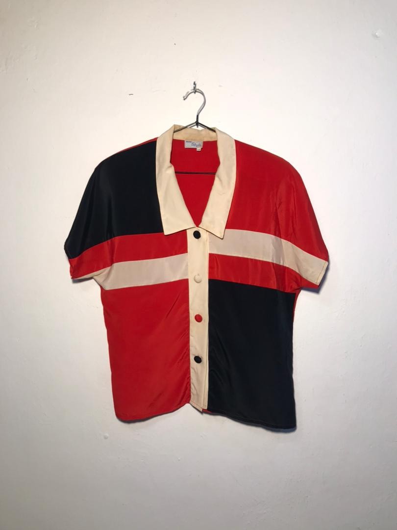 SPIRAL STORE colorblock short sleeve button-up shirt with cream collar and trim. Red, black, and cream panels.