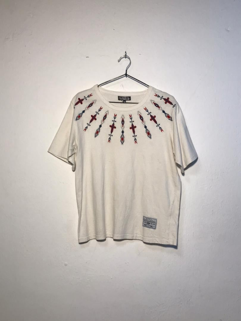SPIRAL STORE cream cotton t-shirt with embroidered tribal-inspired pattern around the neckline.