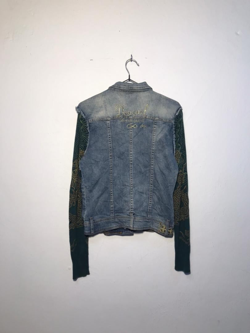 SPIRAL STORE denim jacket with green patterned sleeves and gold embroidered logo on back.