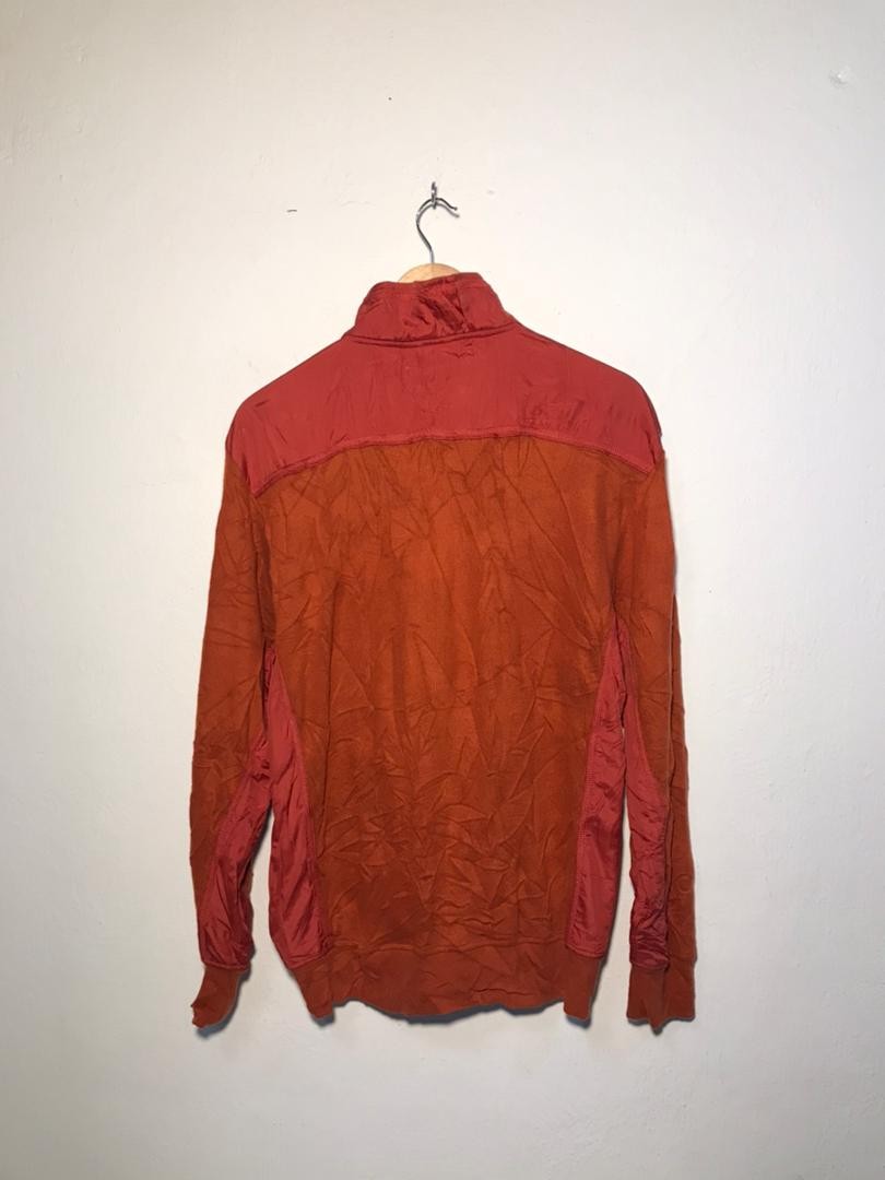 SPIRAL STORE orange and red colorblock long sleeve hoodie with contrasting panels and a mock neck.