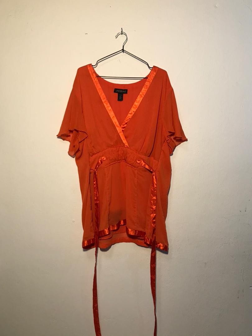 SPIRAL STORE orange sheer kimono-style top with satin trim and tie waist. Short flutter sleeves.