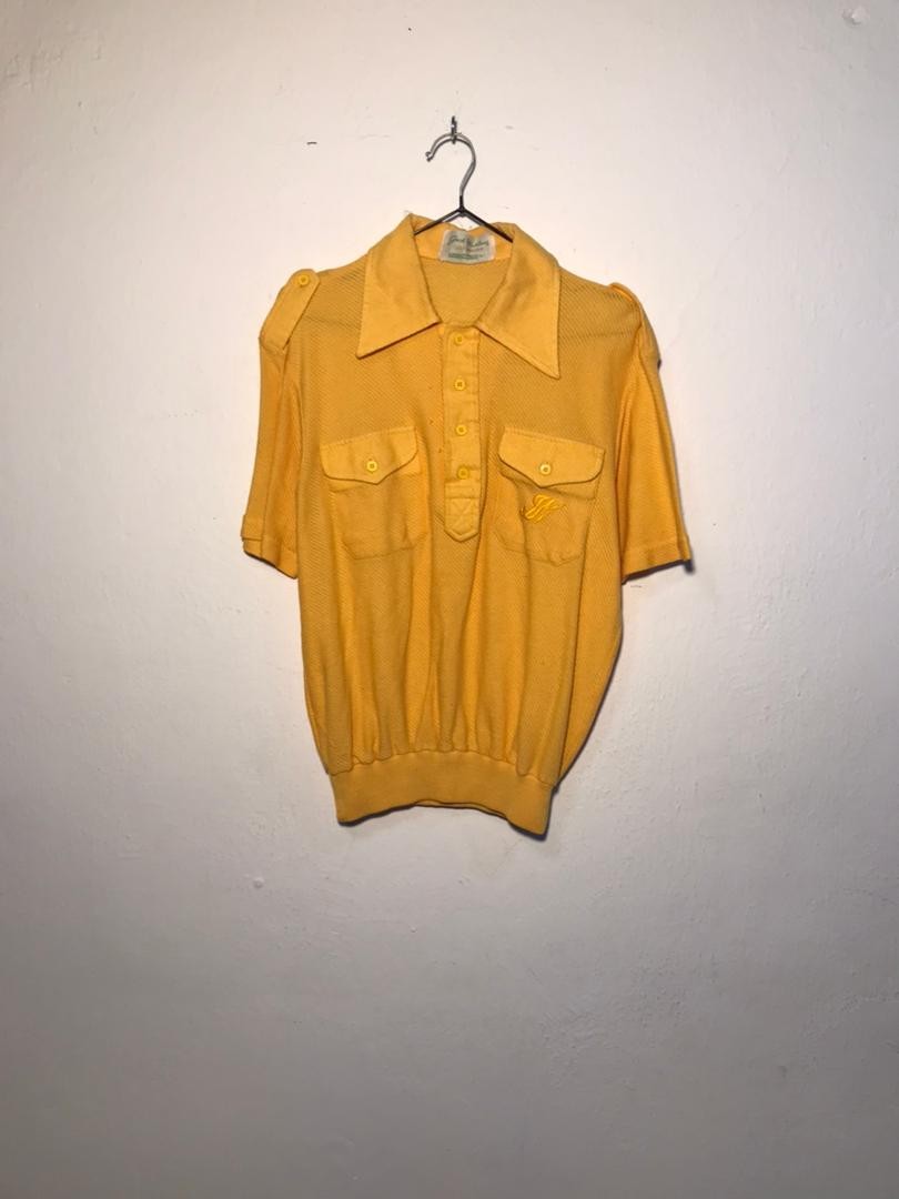 SPIRAL STORE yellow short-sleeve polo shirt with button-up collar, two chest pockets, and embroidered logo.